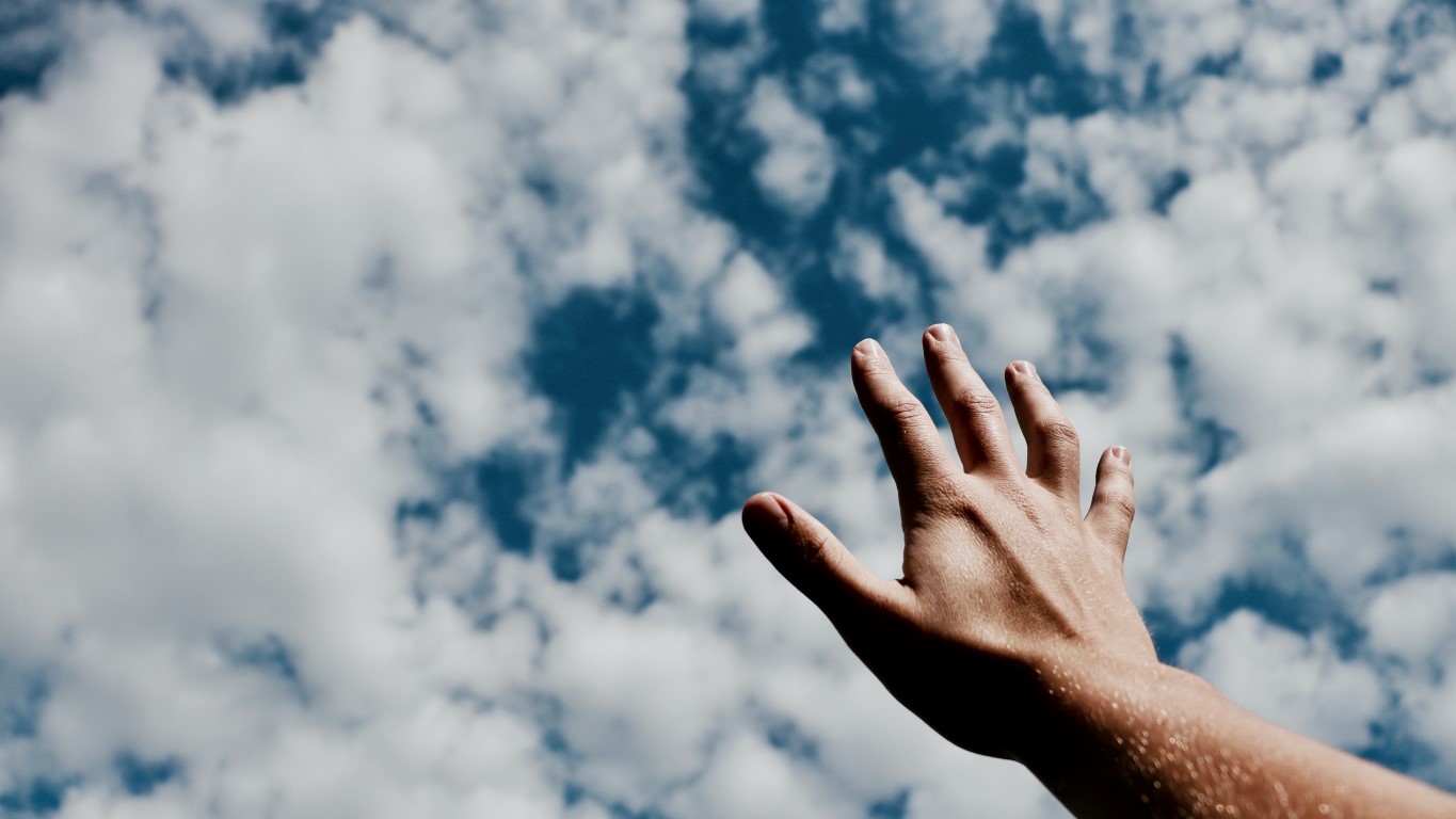 Hand reaching to the sky